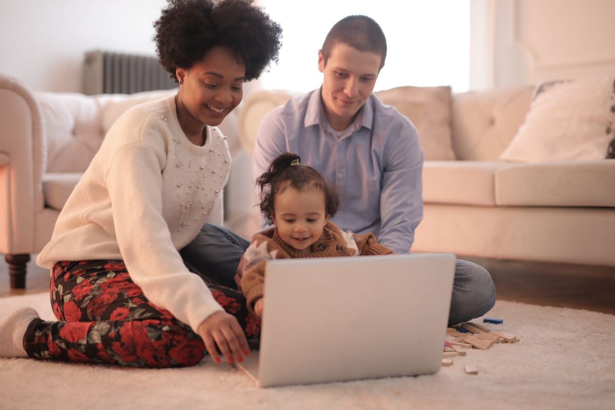 A family listening to a story together on the living-room floor